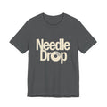Gray t-shirt with 'Needle Drop' text on a white background