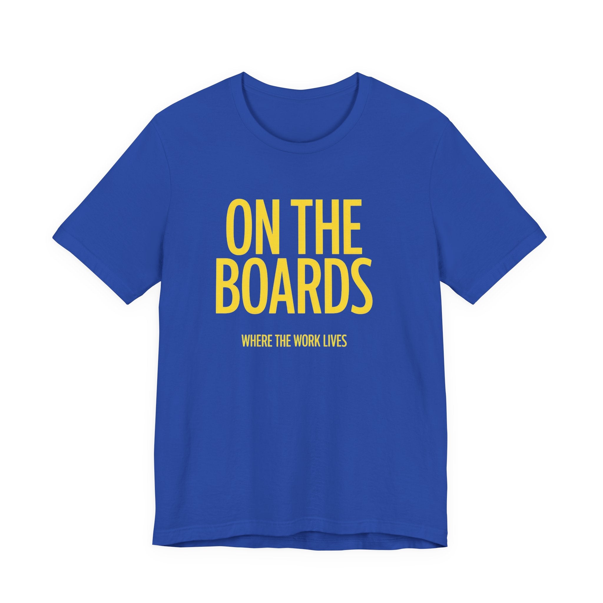 Blue t-shirt with yellow text 'ON THE BOARDS' on a white background