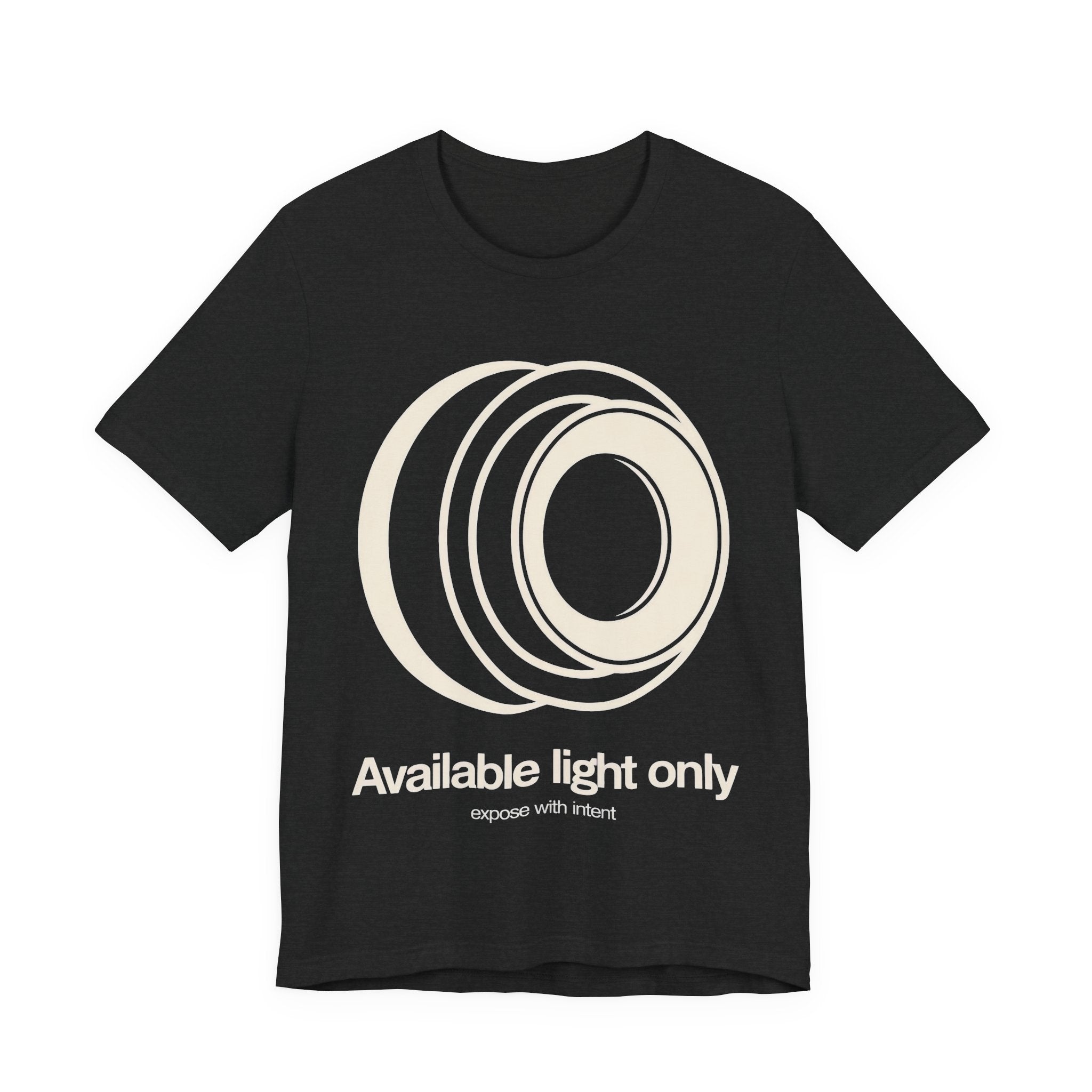 Black t-shirt with white camera lens graphic and text 'Available light only' on a white background