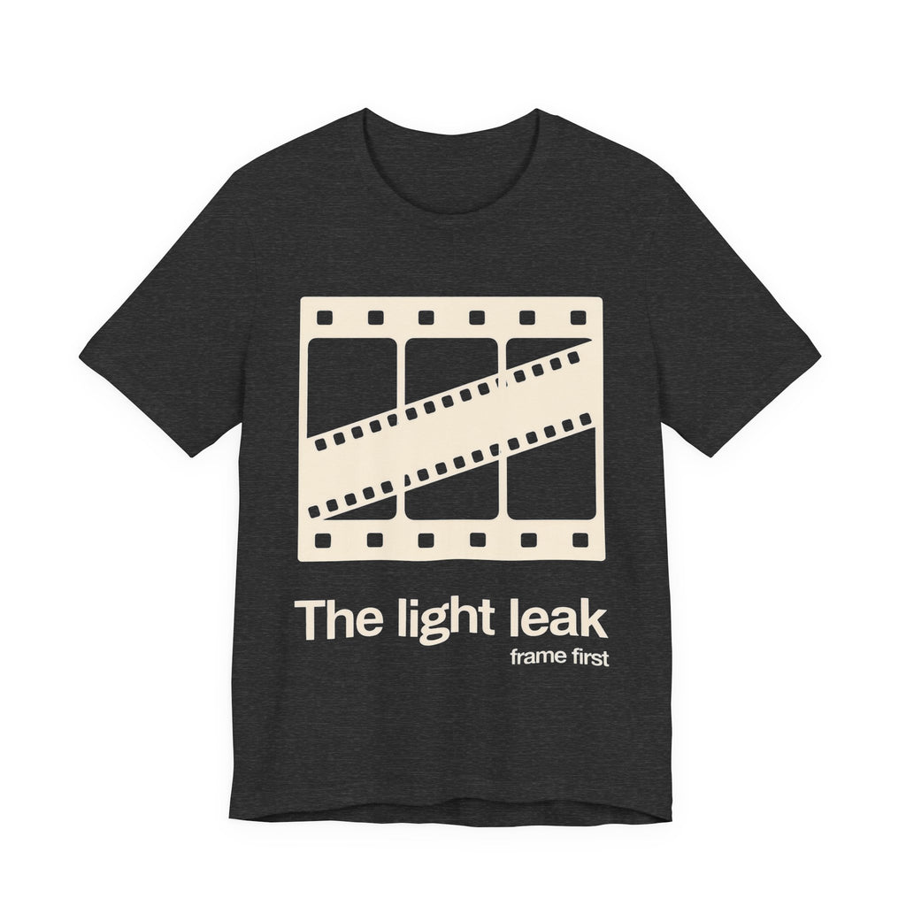 Dark gray t-shirt with a film reel design and white 'The light leak frame first' text on a white background