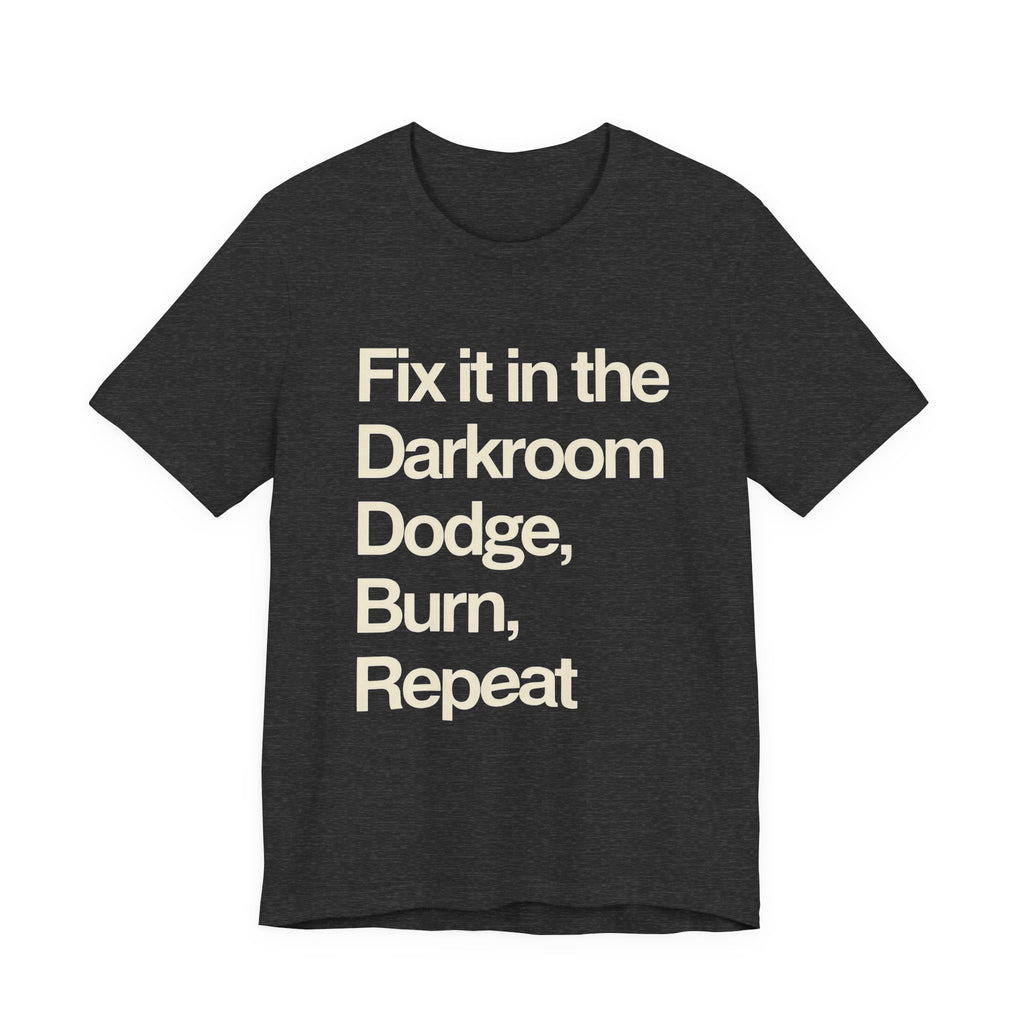 Black t-shirt with white text 'Fix it in the Darkroom Dodge, Burn, Repeat' on a white background