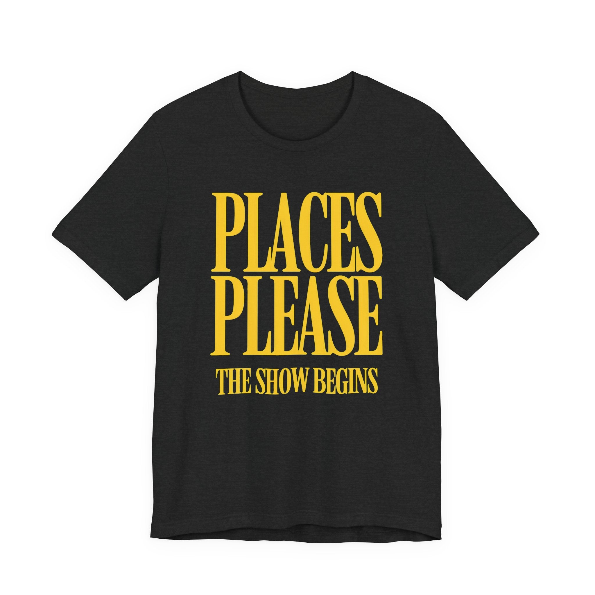 Black t-shirt with yellow text 'PLACES PLEASE THE SHOW BEGINS' on a white background
