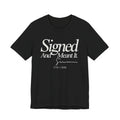 Dark grey t-shirt with white text 'Signed And Meant It. 1776 - 2026' 