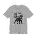 Gray t-shirt with black dog graphic and text 'trained not tamed' on a white background