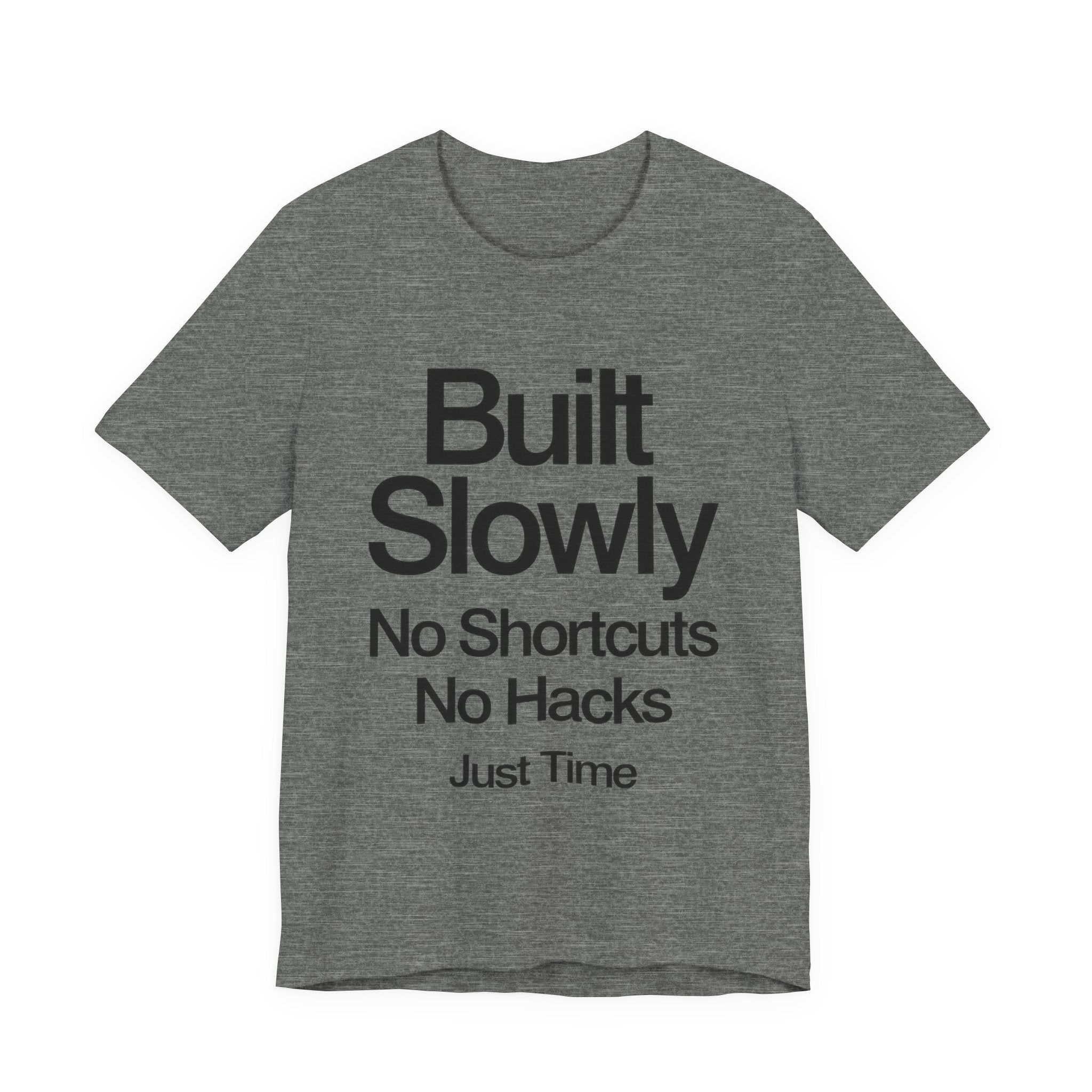 Gray t-shirt with black text 'Built Slowly No Shortcuts No Hacks Just Time' on a white background