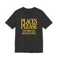Dark grey t-shirt with yellow 'Places Please' text on a white background