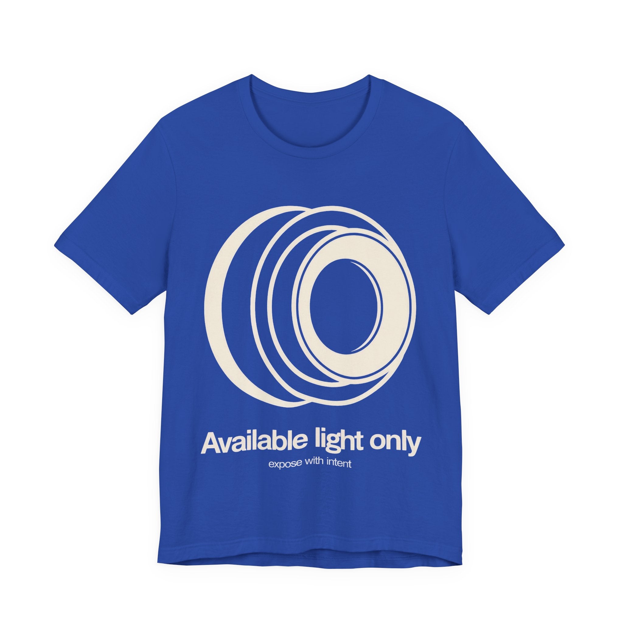 Blue t-shirt with white camera lens graphic and text 'Available light only' on a white background