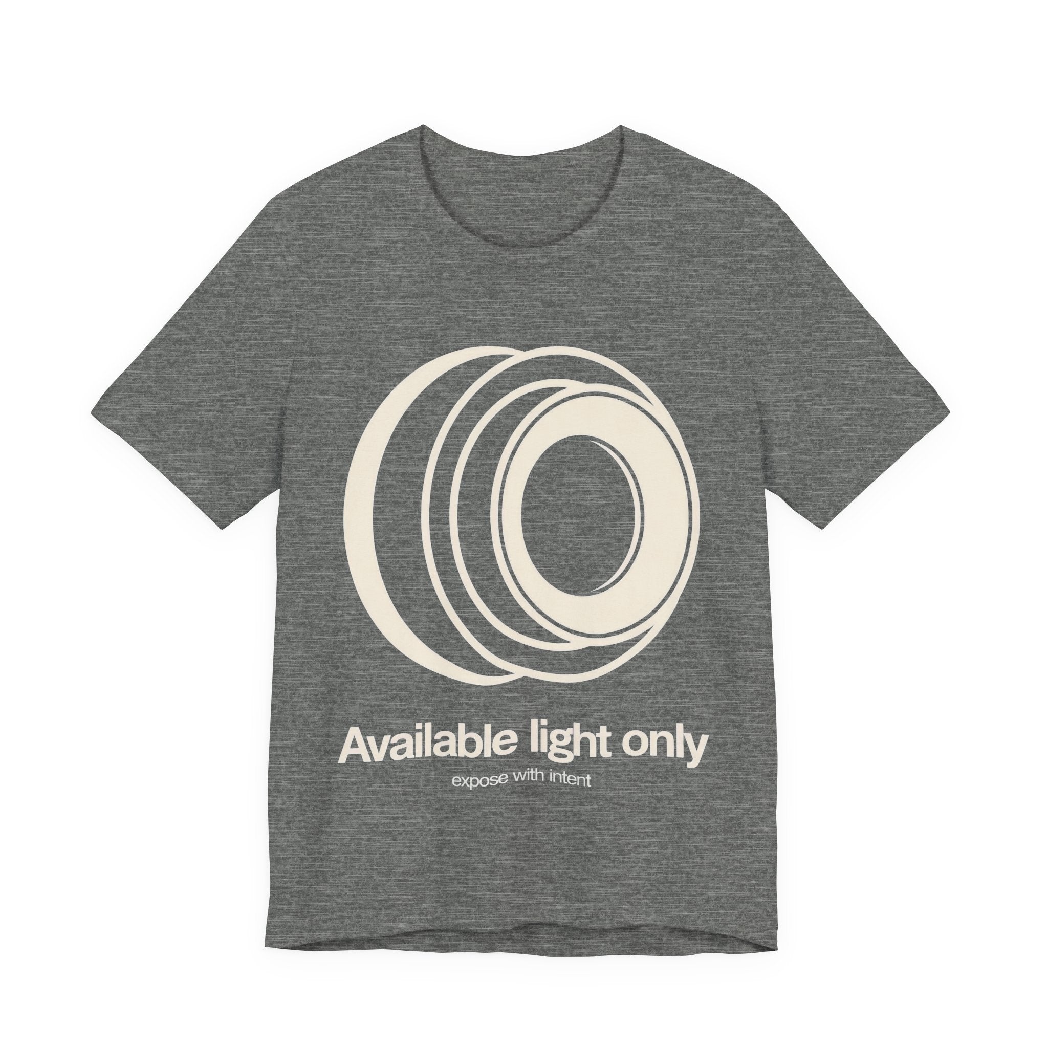 Gray t-shirt with white camera lens graphic and text 'Available light only' on a white background