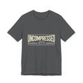 Gray t-shirt with 'UNCOMPRESSED' text on a white background