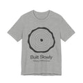 Gray t-shirt with a circular design and text 'Built Slowly Strong takes time' on a white background