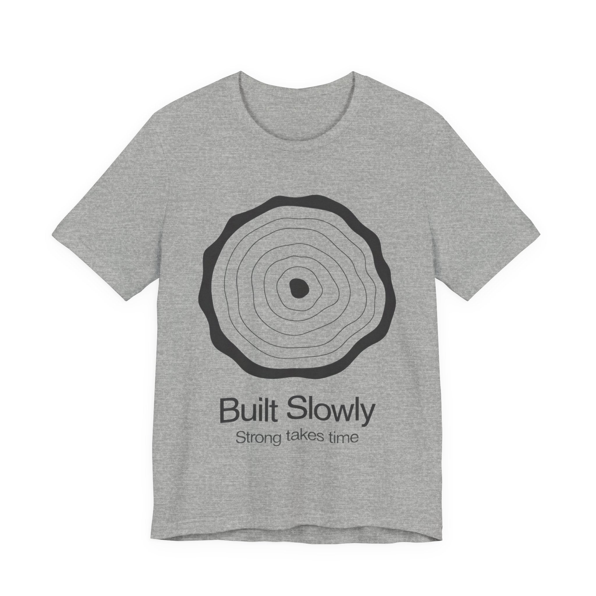 Gray t-shirt with a circular design and text 'Built Slowly Strong takes time' on a white background