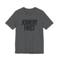 Gray t-shirt with 'JOINERY FIRST' text on a white background