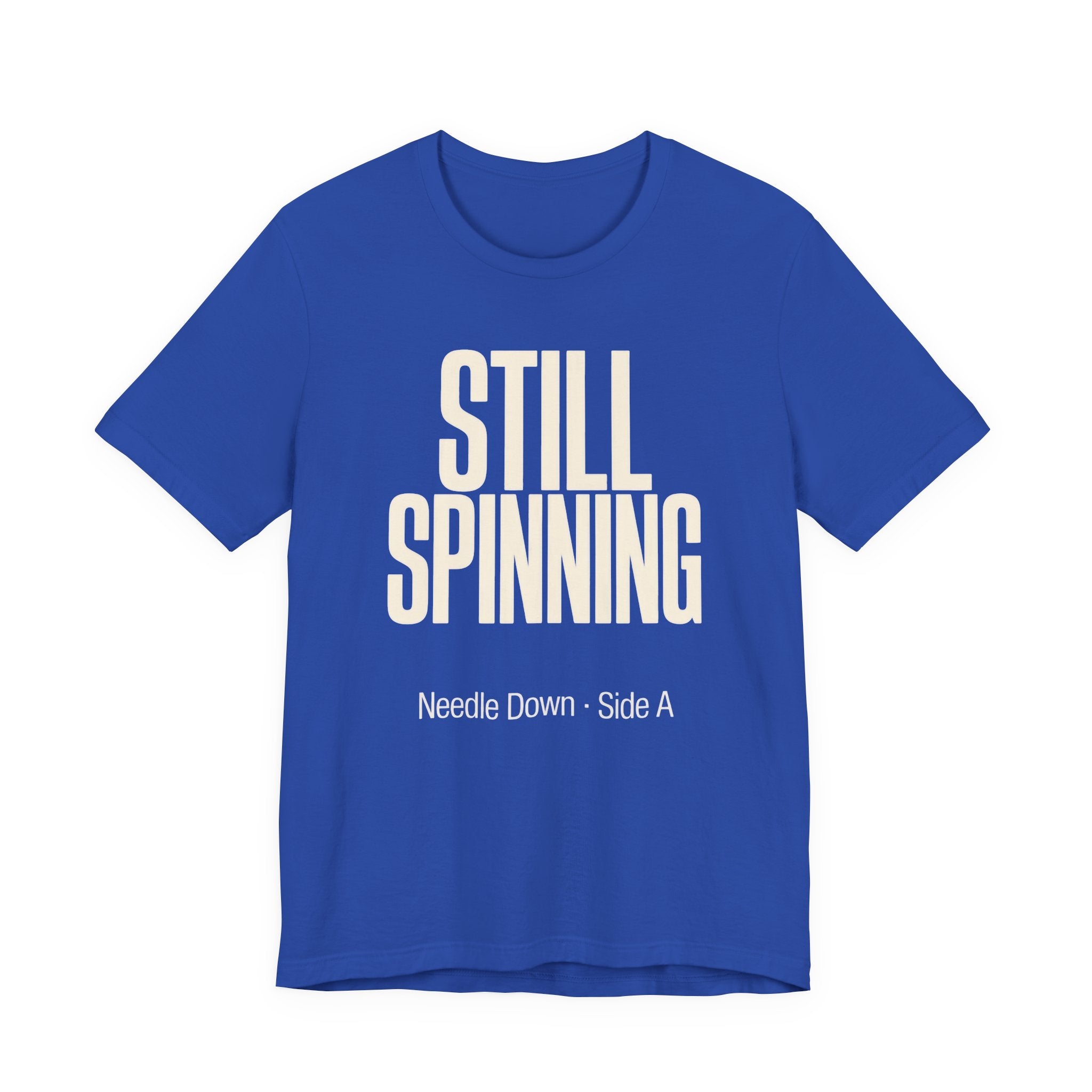 Blue t-shirt with 'STILL SPINNING' text on a white background