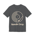 Gray t-shirt with 'Needle Drop' graphic design on a white background