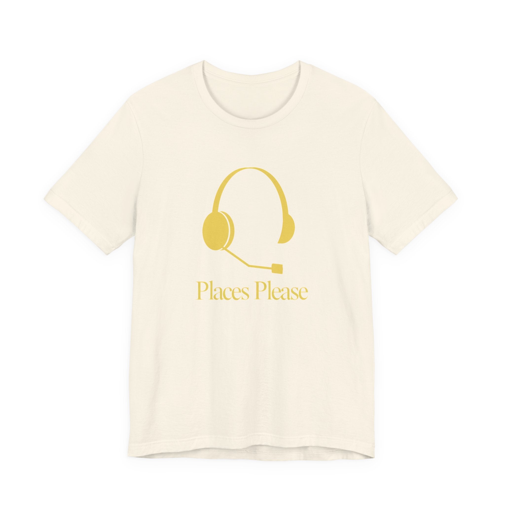 Beige t-shirt with a gold headset graphic and 'Places Please' text on a white background