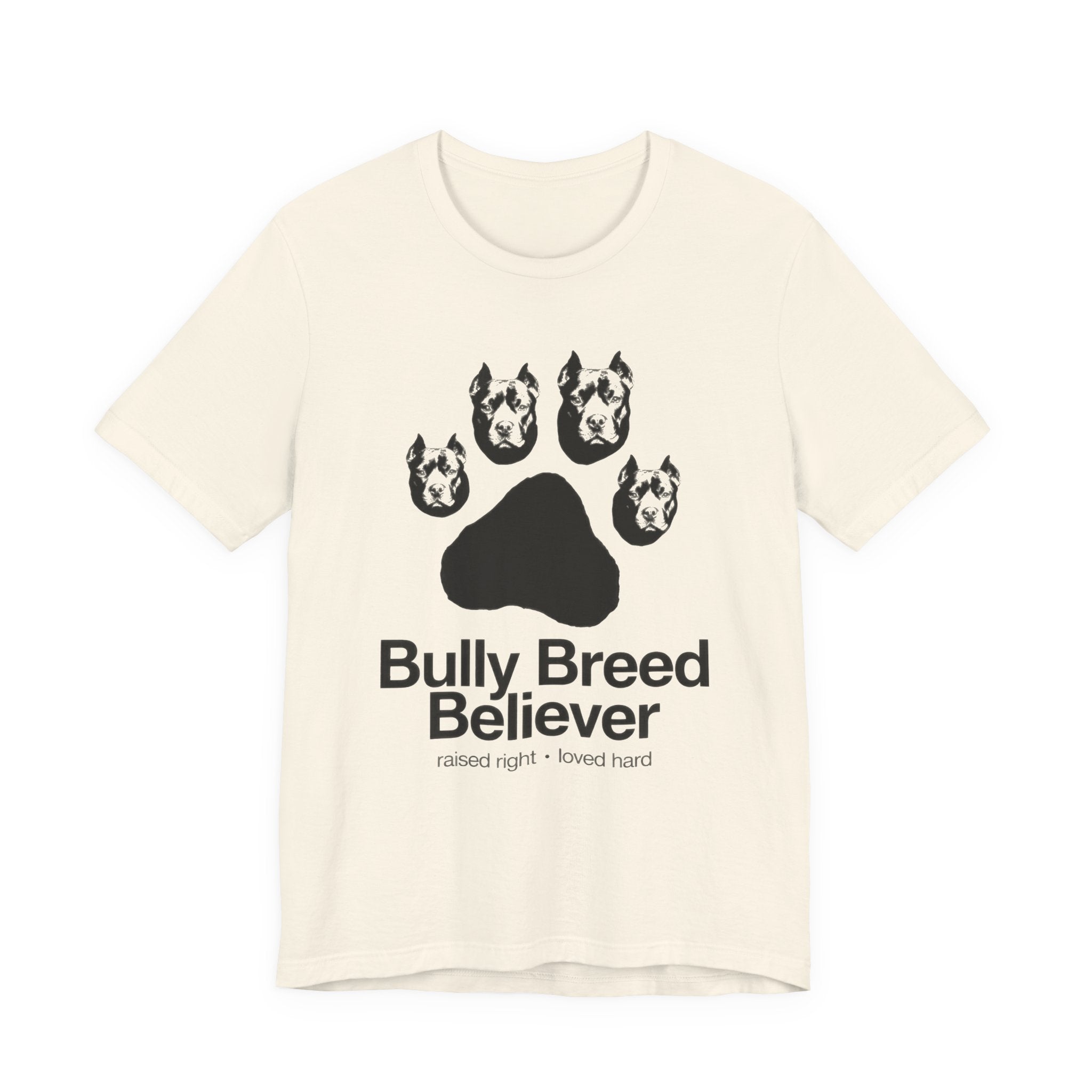 Beige t-shirt with graphic of dog heads and text 'Bully Breed Believer' on a white background