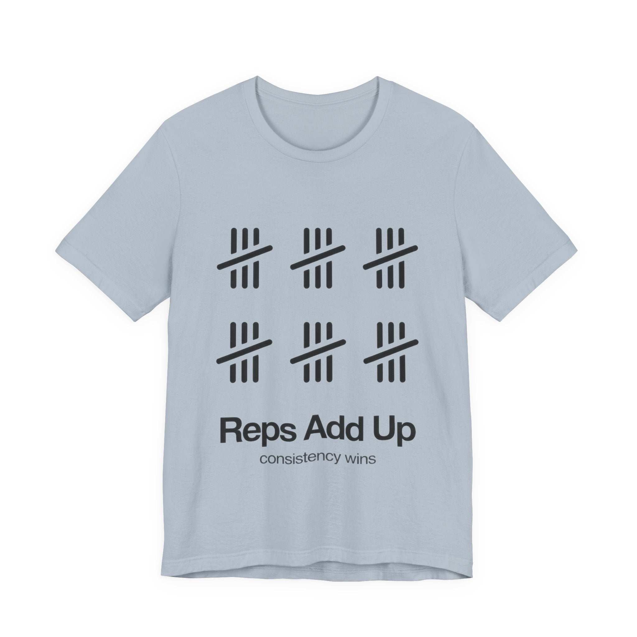 Light blue t-shirt with black graphic design and text 'Reps Add Up, consistency wins' on a plain background