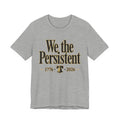 Gray t-shirt with 'We the Persistent' text and bell graphic on a white background