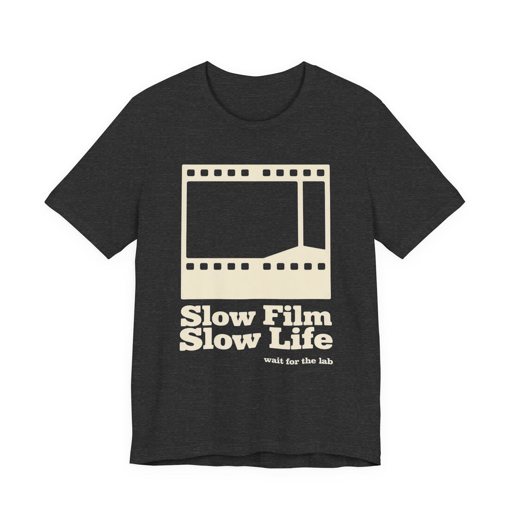Black t-shirt with a film strip graphic and text 'Slow Film Slow Life' on a white background