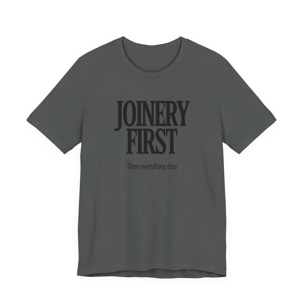 Grey t-shirt with 'JOINERY FIRST Then everything else' text on a white background