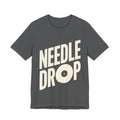 Gray t-shirt with 'NEEDLE DROP' text on a white background