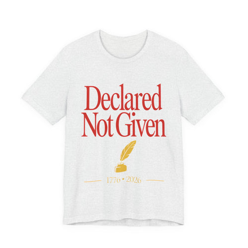 White t-shirt with red text 'Declared Not Given' and a yellow feather and inkwell on a white background