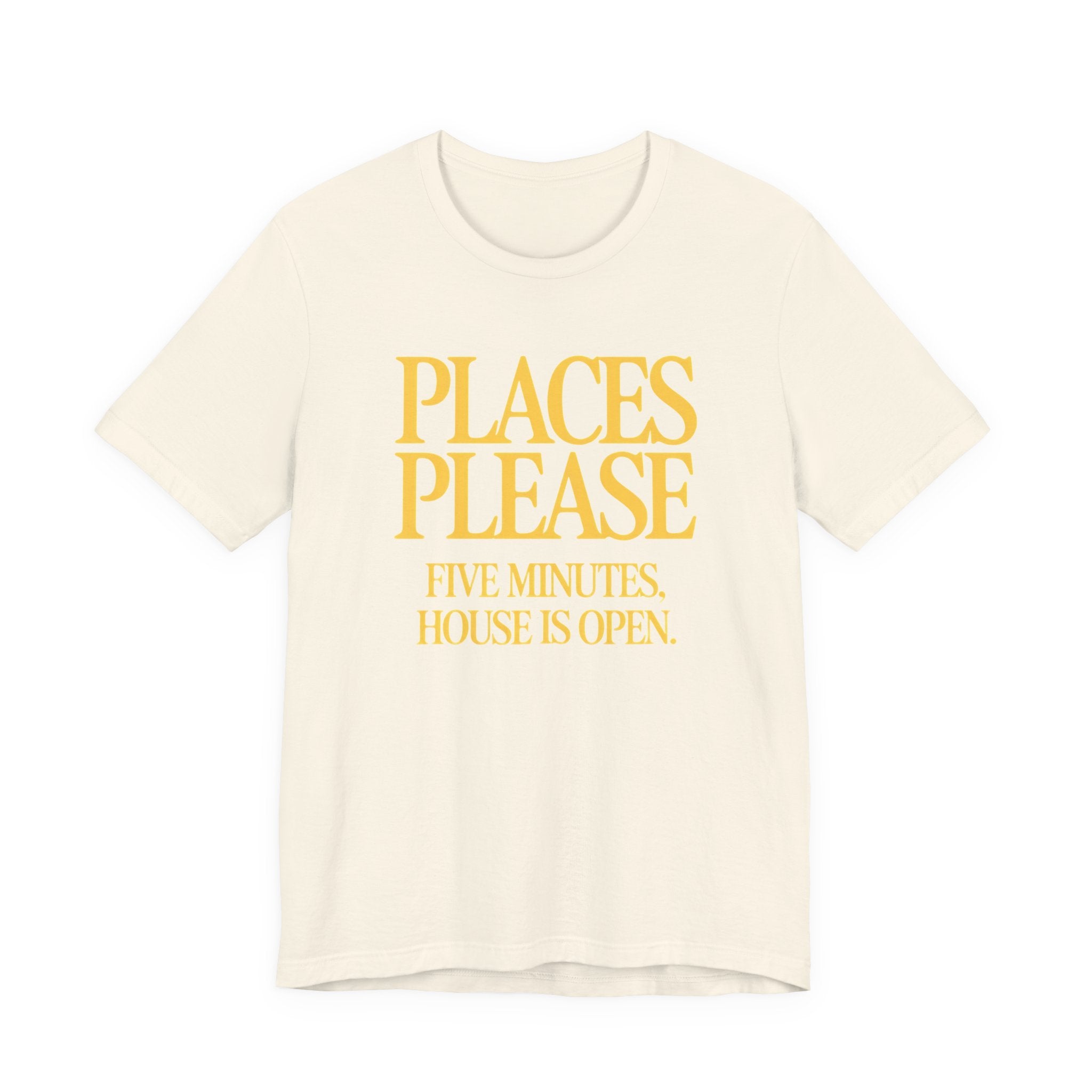 Beige t-shirt with yellow 'Places Please' text on a white background