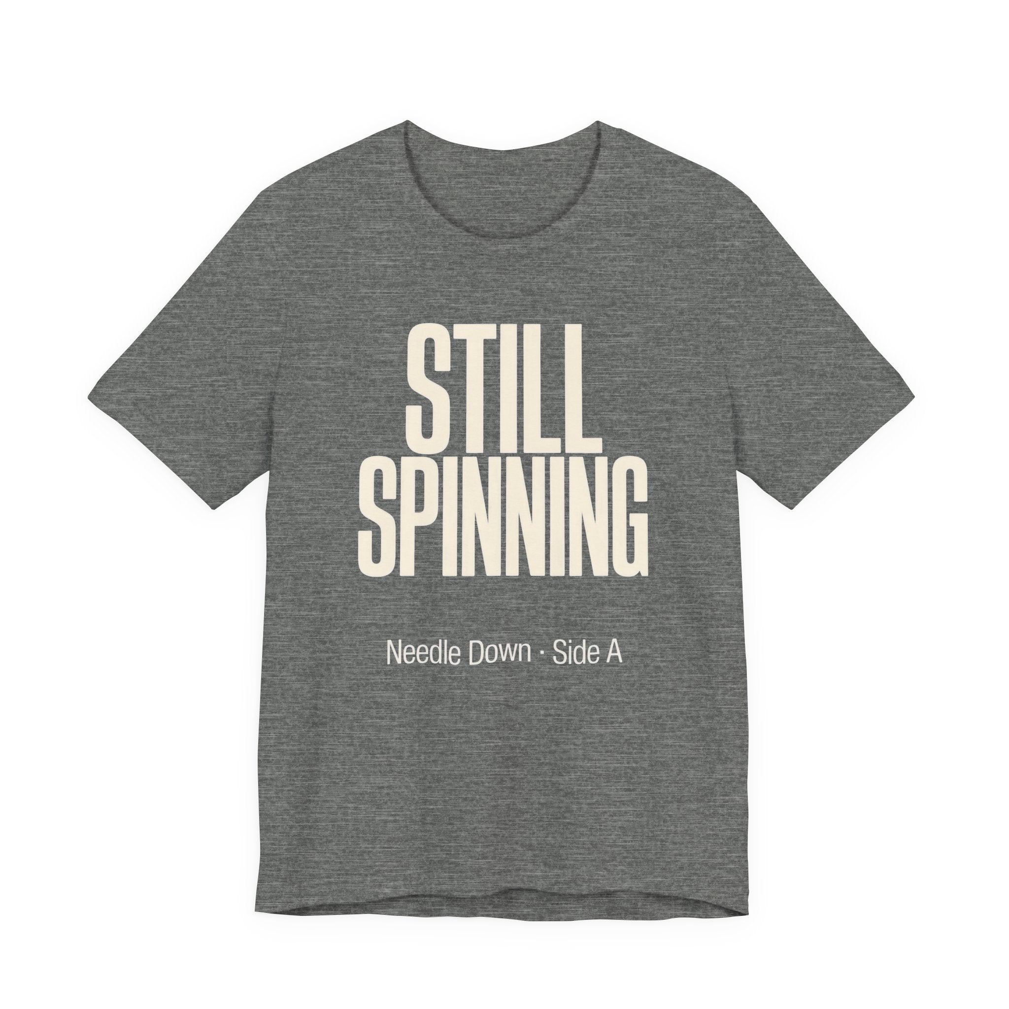 Gray t-shirt with 'STILL SPINNING' text on a white background