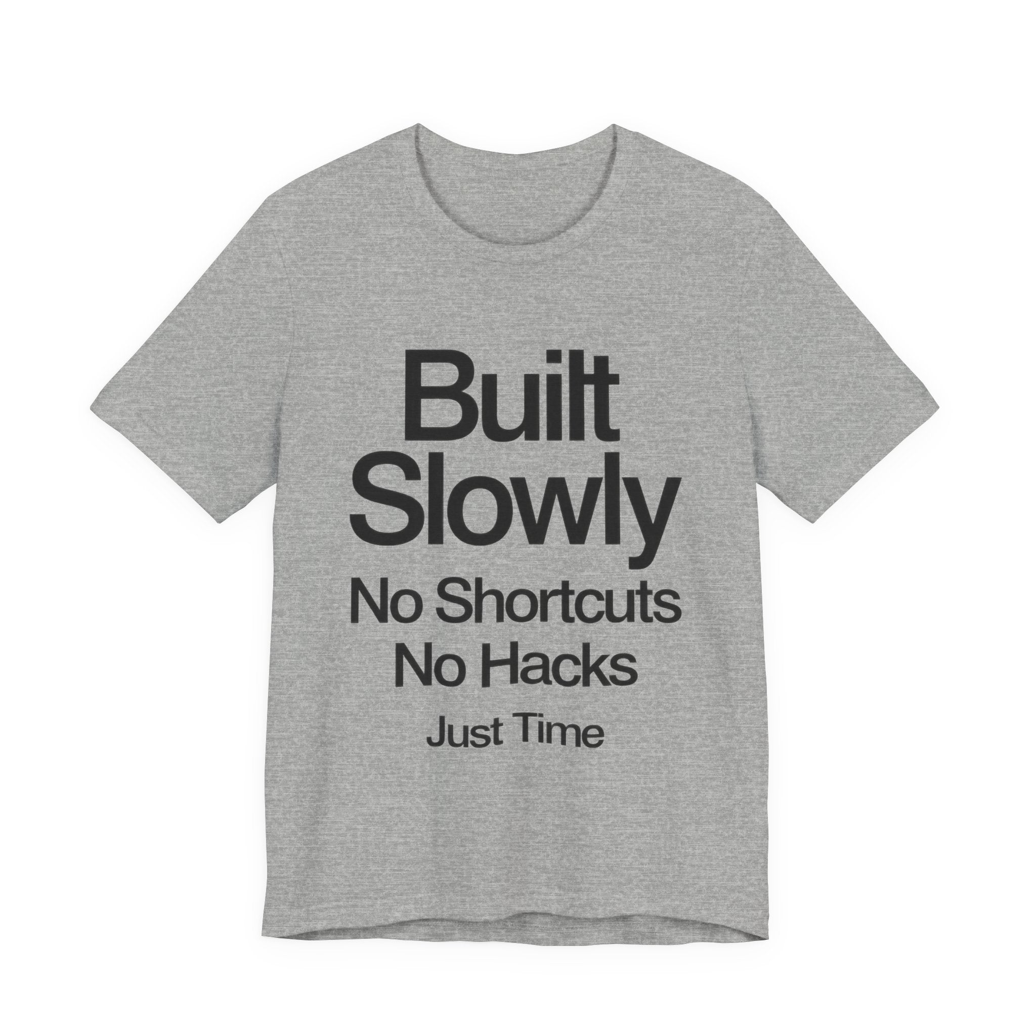 Gray t-shirt with black text 'Built Slowly No Shortcuts No Hacks Just Time' on a white background