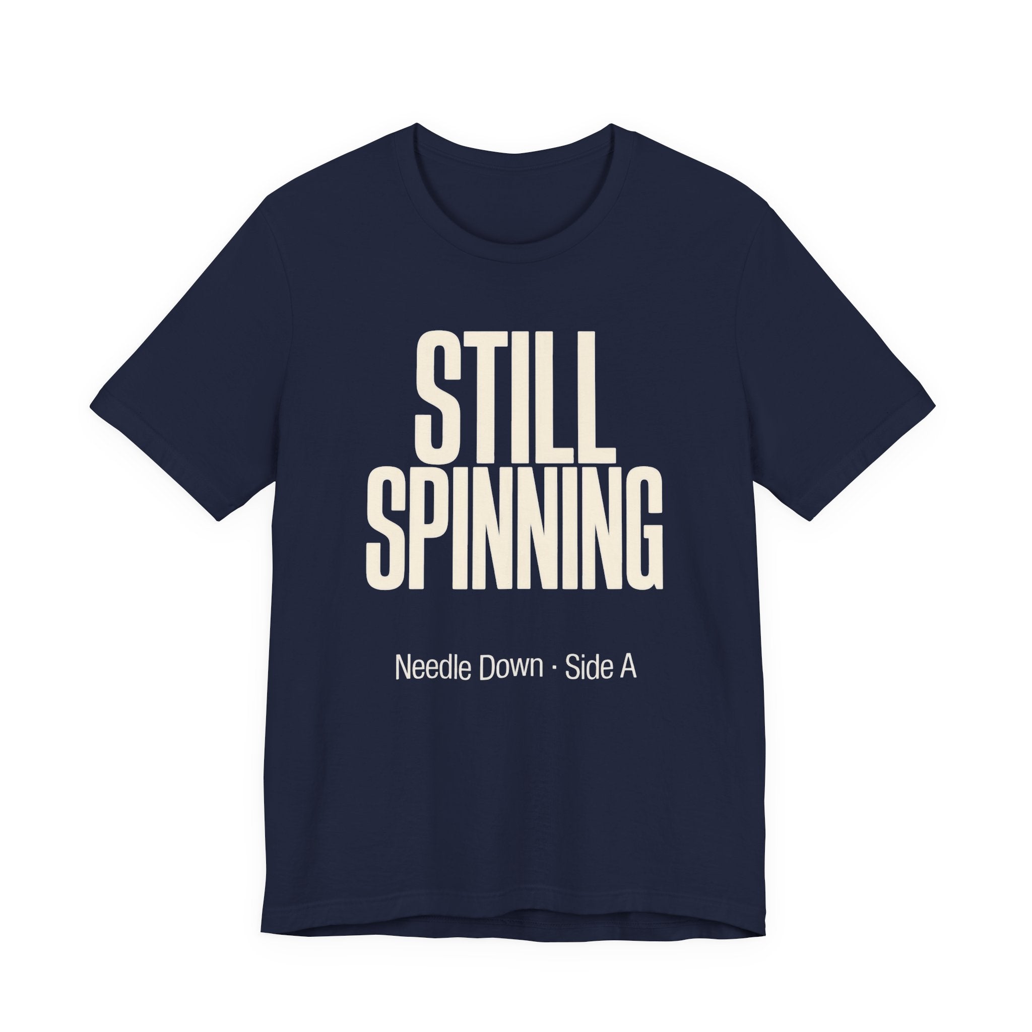 Navy blue t-shirt with 'STILL SPINNING' text on a white background