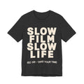 Black t-shirt with 'Slow Film Slow Life' text on a white background