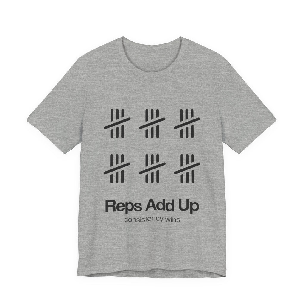 Gray t-shirt with black graphic design and text 'Reps Add Up, consistency wins' on a plain background