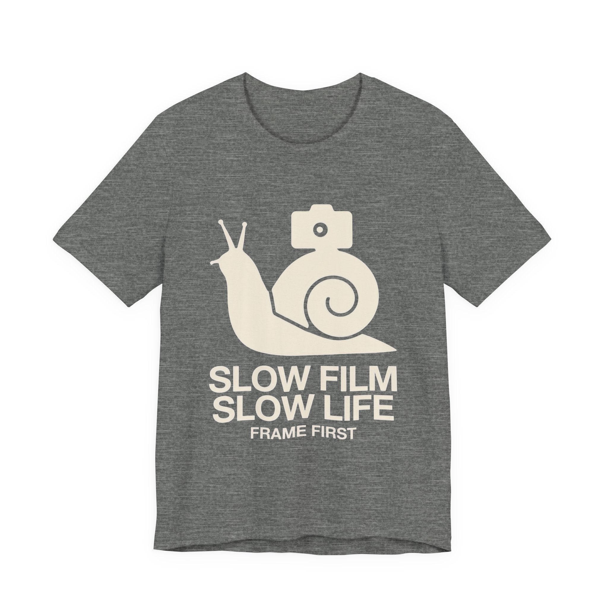 Gray t-shirt with a snail and camera graphic and text 'Slow Film Slow Life Frame First' on a white background