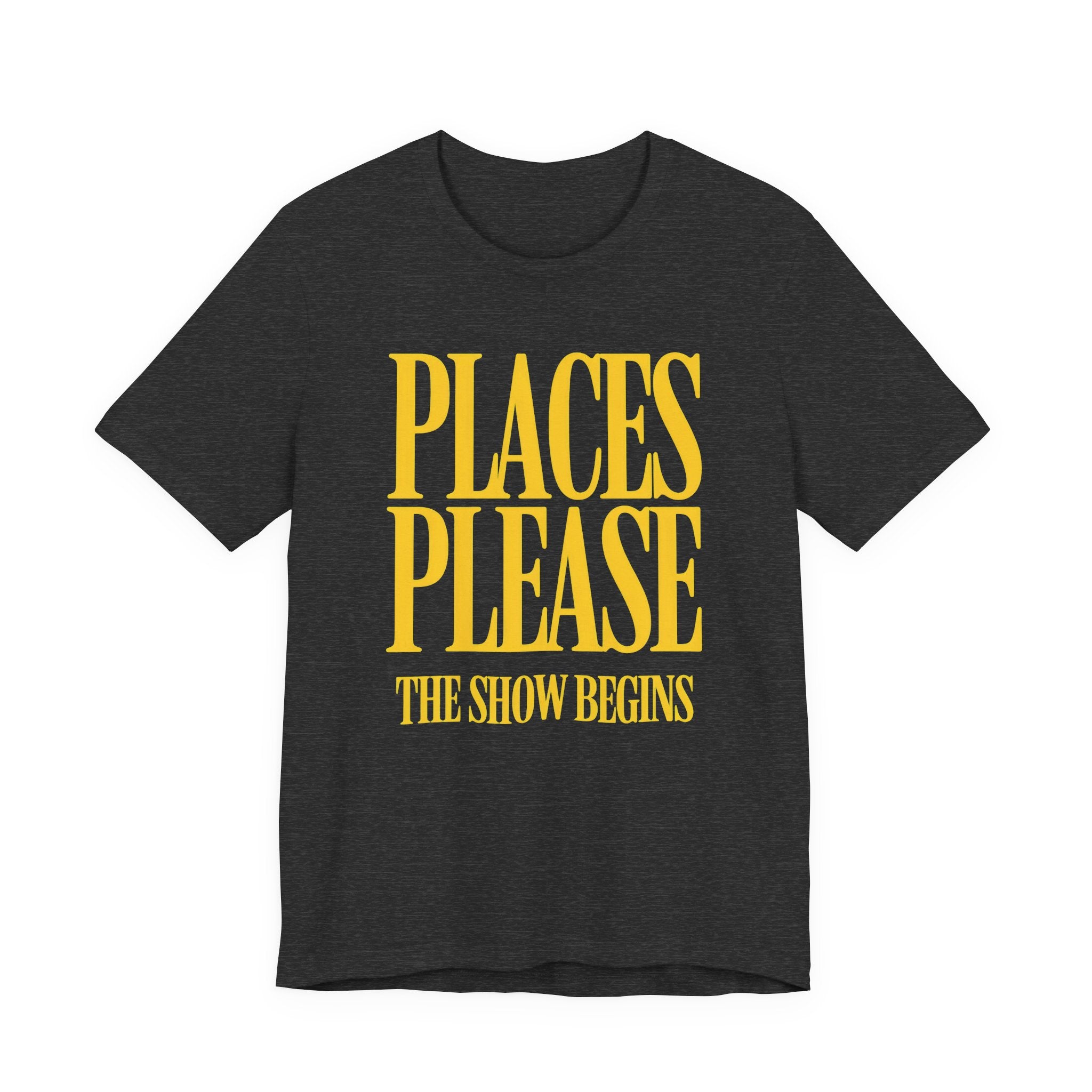 Black t-shirt with yellow text 'PLACES PLEASE THE SHOW BEGINS' on a white background