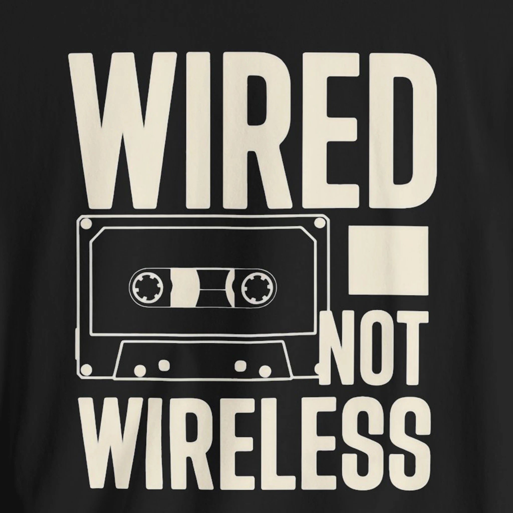 Black t-shirt with a white cassette tape graphic and text 'WIRED NOT WIRELESS' on a black background