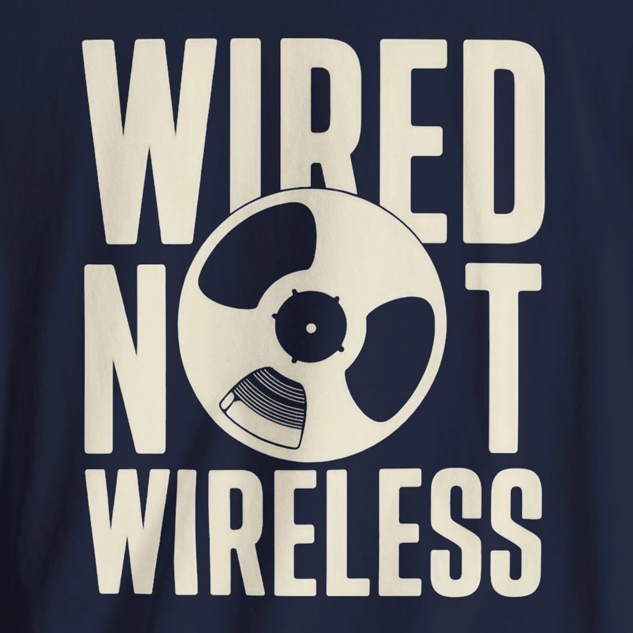 Navy blue t-shirt with 'WIRED NOT WIRELESS' text and reel-to-reel tape graphic.