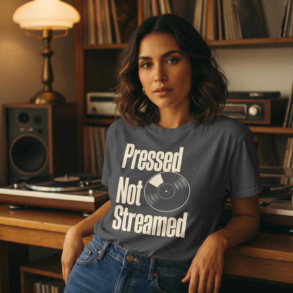 Woman wearing a 'Pressed Not Streamed' t-shirt in a record player room.