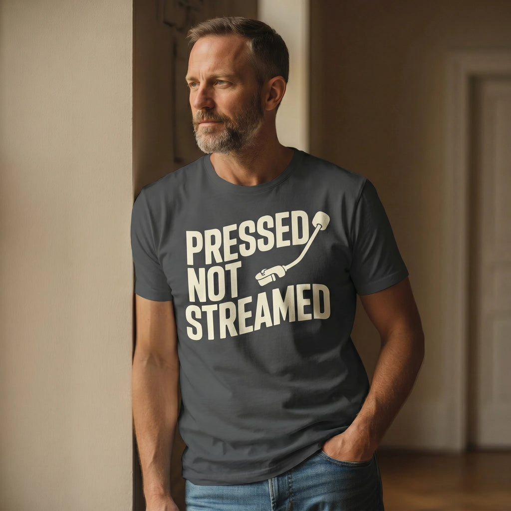 Man wearing a t-shirt with 'Pressed Not Streamed' text in a room.