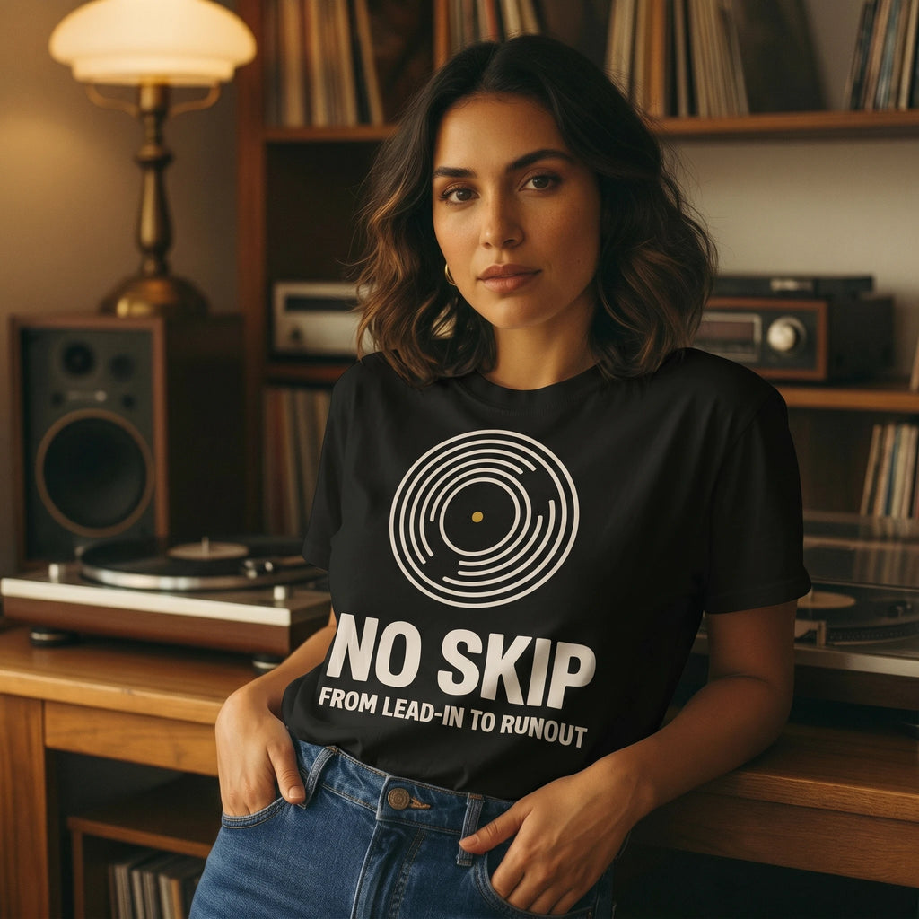Woman wearing a black t-shirt with 'No Skip' design in a record player room.