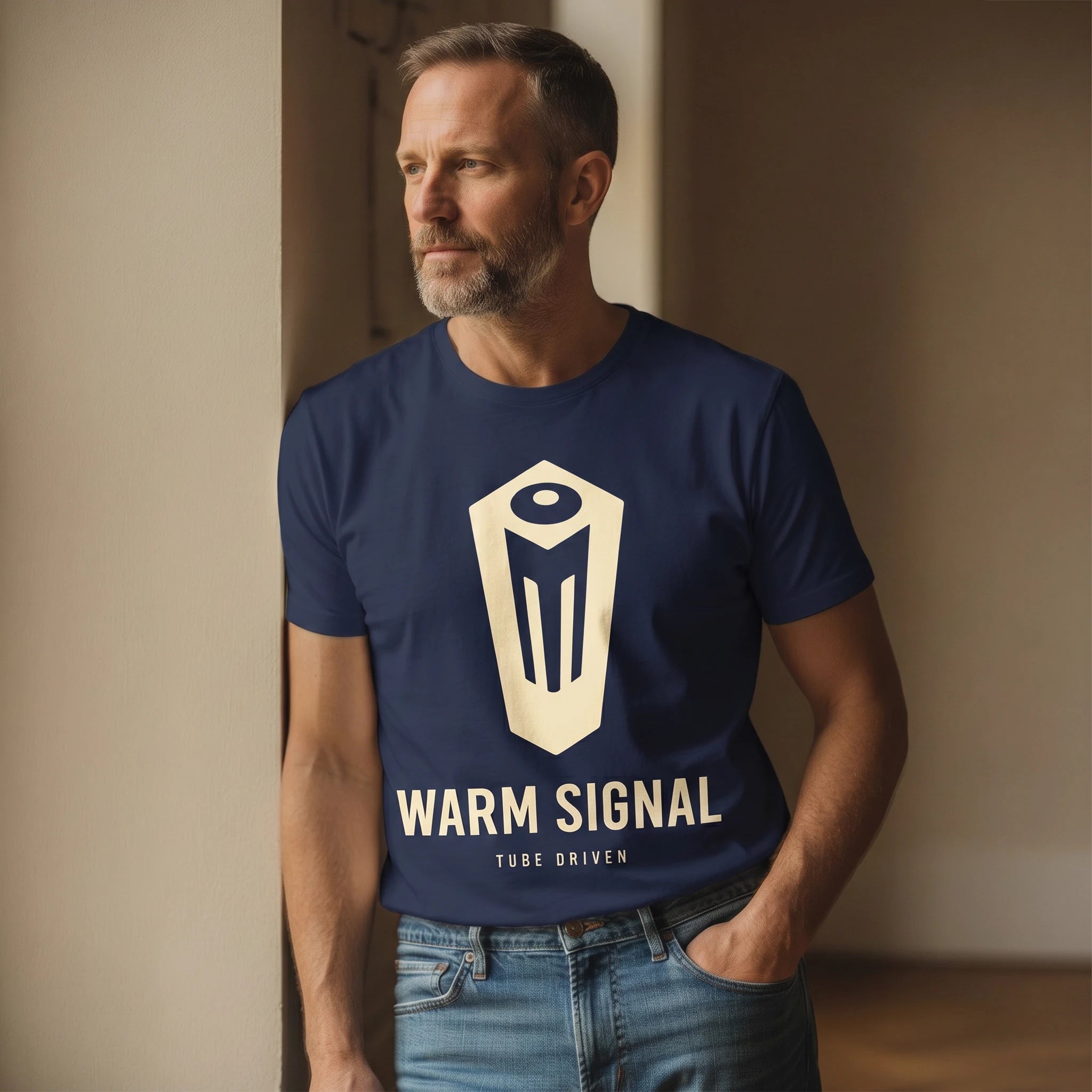 Man wearing a navy blue t-shirt with 'Warm Signal' logo and text, standing against a neutral wall.