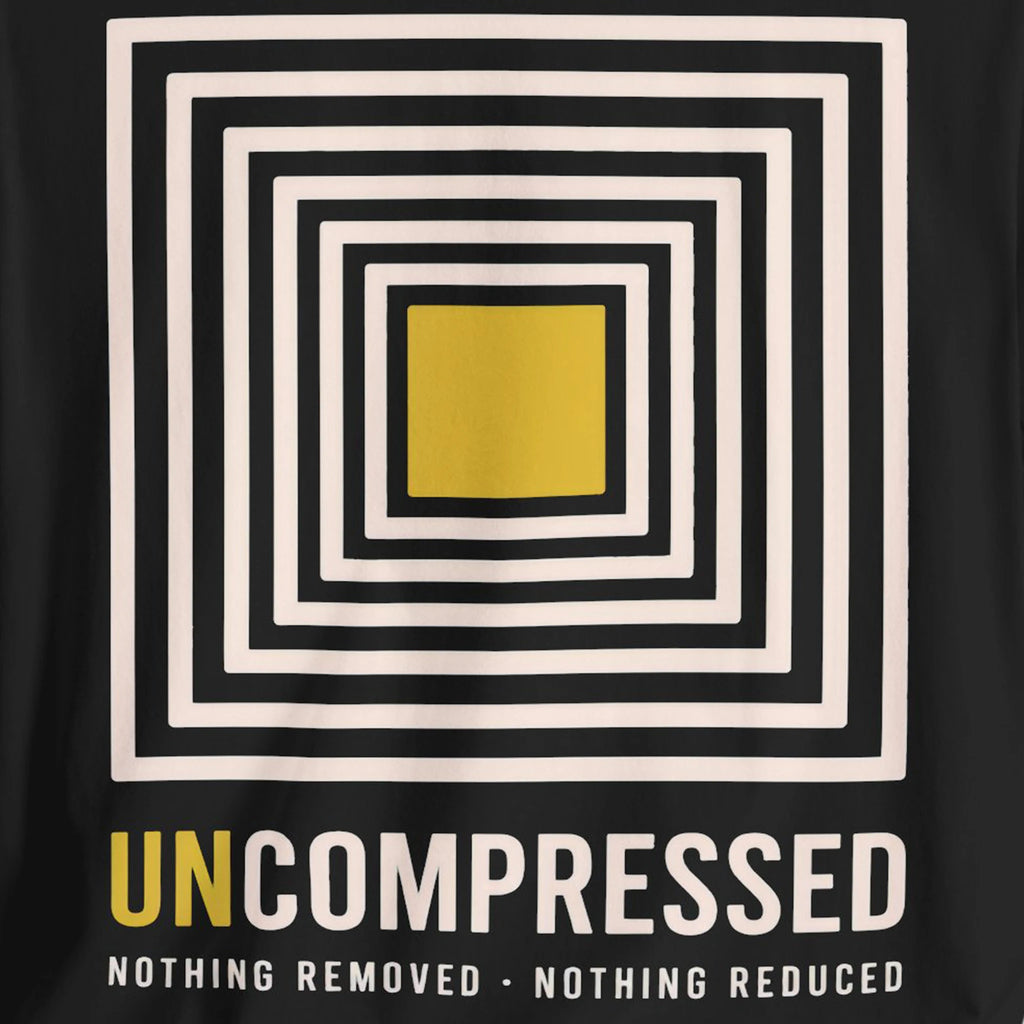 Black t-shirt with a yellow square and concentric squares design, featuring the text 'UNCOMPRESSED'.