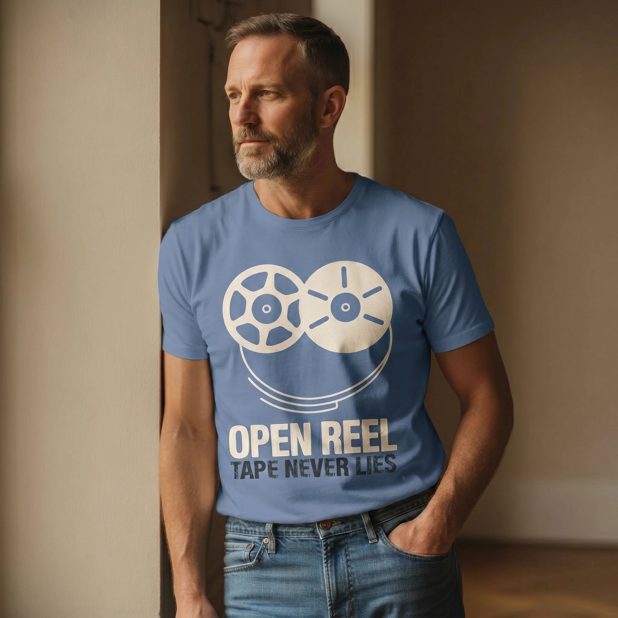 Man wearing a blue t-shirt with a graphic and text 'Open Reel Tape Never Lies' against a neutral background.