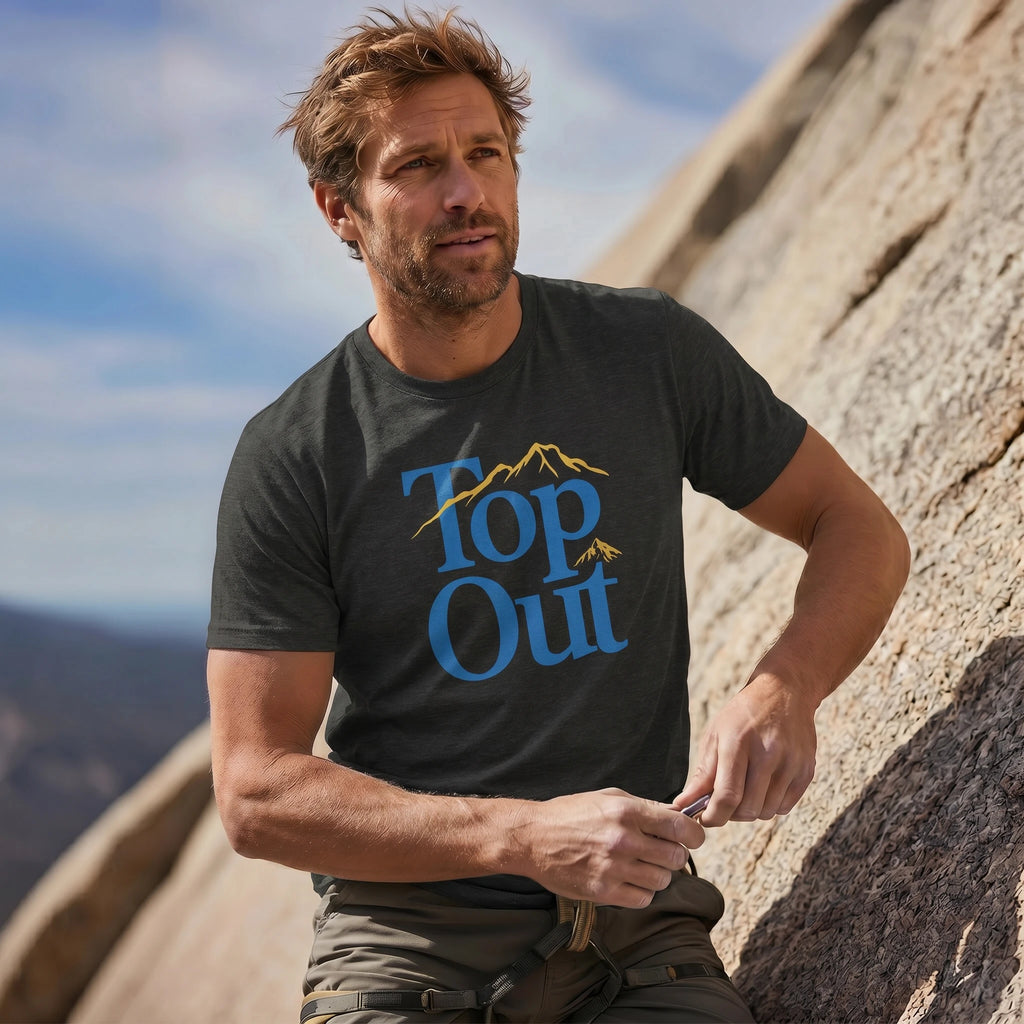 Man wearing a 'Top Out' t-shirt on a mountain