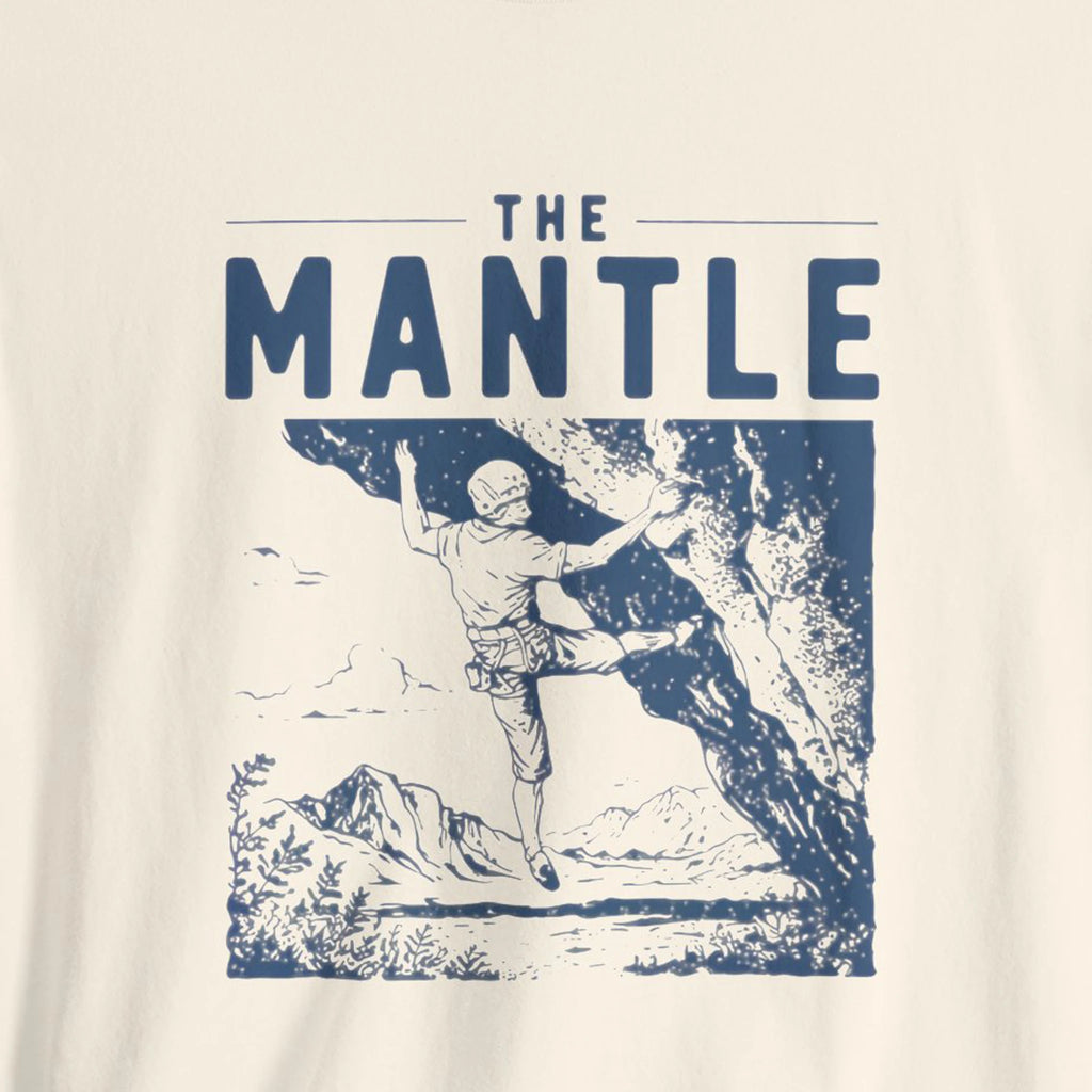 T-shirt with graphic of a climber and 'The Mantle' text on a beige background