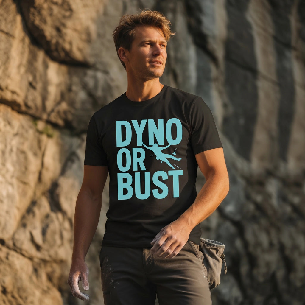 Man wearing a black t-shirt with 'DYNO OR BUST' text against a stone wall.
