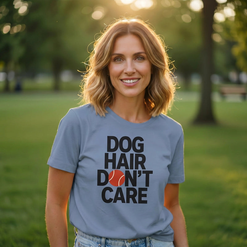 Woman wearing a t-shirt with 'Dog Hair Don't Care' text in a park setting