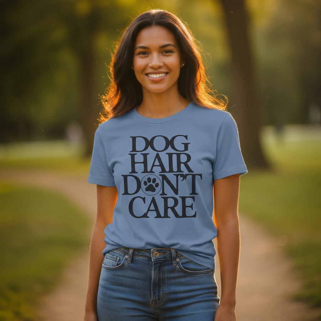 Woman wearing a blue t-shirt with 'Dog Hair Don't Care' text in a park setting