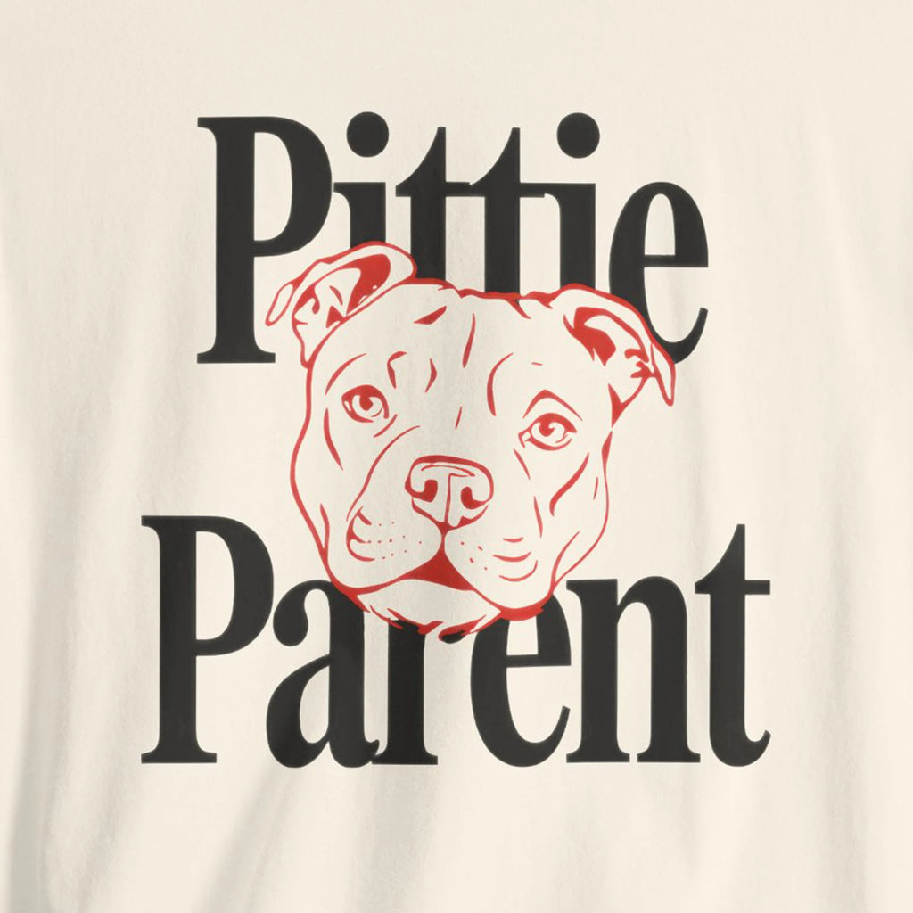 T-shirt with 'Pittie Parent' text and a dog illustration on a beige background