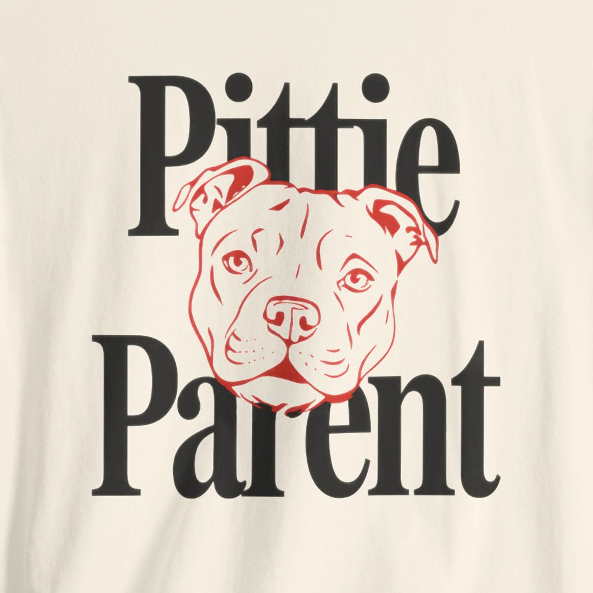 T-shirt with 'Pittie Parent' text and a dog illustration on a beige background
