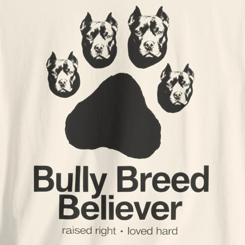 T-shirt with graphic of dog heads and text 'Bully Breed Believer' on a beige background
